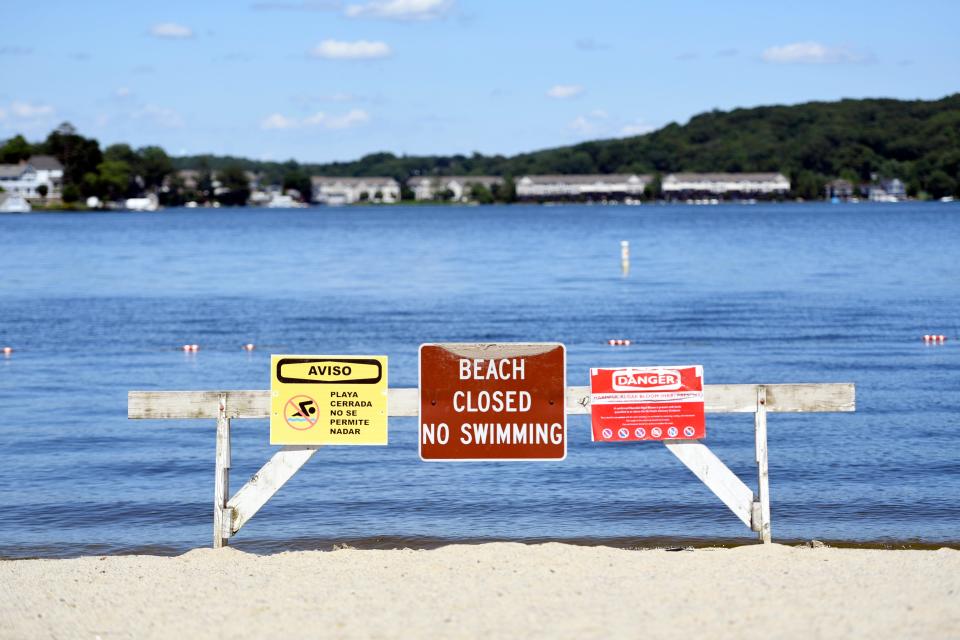 Signs on the closed beach at Hopatcong State Park warn residents of the Harmful Algae Bloom in Lake Hopatcong on Monday, July 1, 2019.