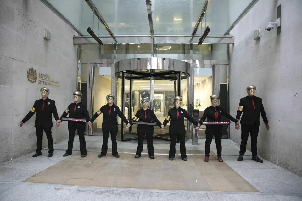 Extinction Rebellion climate protesters form a line after glueing themselves to the entrances of the London Stock Exchange in the City of London, Thursday April 25, 2019. (Isabel Infantes/PA via AP)