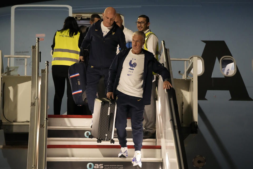 France's national team coach Didier Deschamps, right, arrives with his team at Hamad International airport in Doha, Qatar, Wednesday, Nov. 16, 2022, ahead of the upcoming World Cup. France will play their first match in the World Cup against Australia on Nov. 22. (AP Photo/Hassan Ammar)