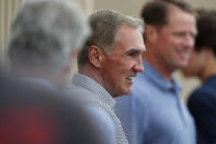 Former Denver Broncos head coach Mike Shanahan, center, looks on as his son, San Francisco 49ers head coach Kyle Shanahan (not shown), directs his team during a combined NFL football training camp with the San Francisco 49ers at the Broncos' headquarters Friday, Aug. 16, 2019, in Englewood, Colo. (AP Photo/David Zalubowski)