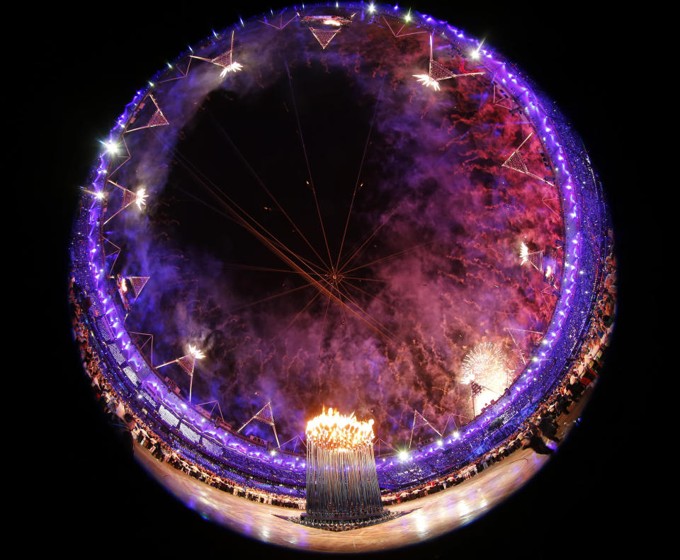 Fireworks explode after the Olympic cauldron was lit during the opening ceremony of the London 2012 Olympic Games at the Olympic Stadium July 27, 2012. REUTERS/Kai Pfaffenbach (BRITAIN - Tags: SPORT OLYMPICS TPX IMAGES OF THE DAY) 