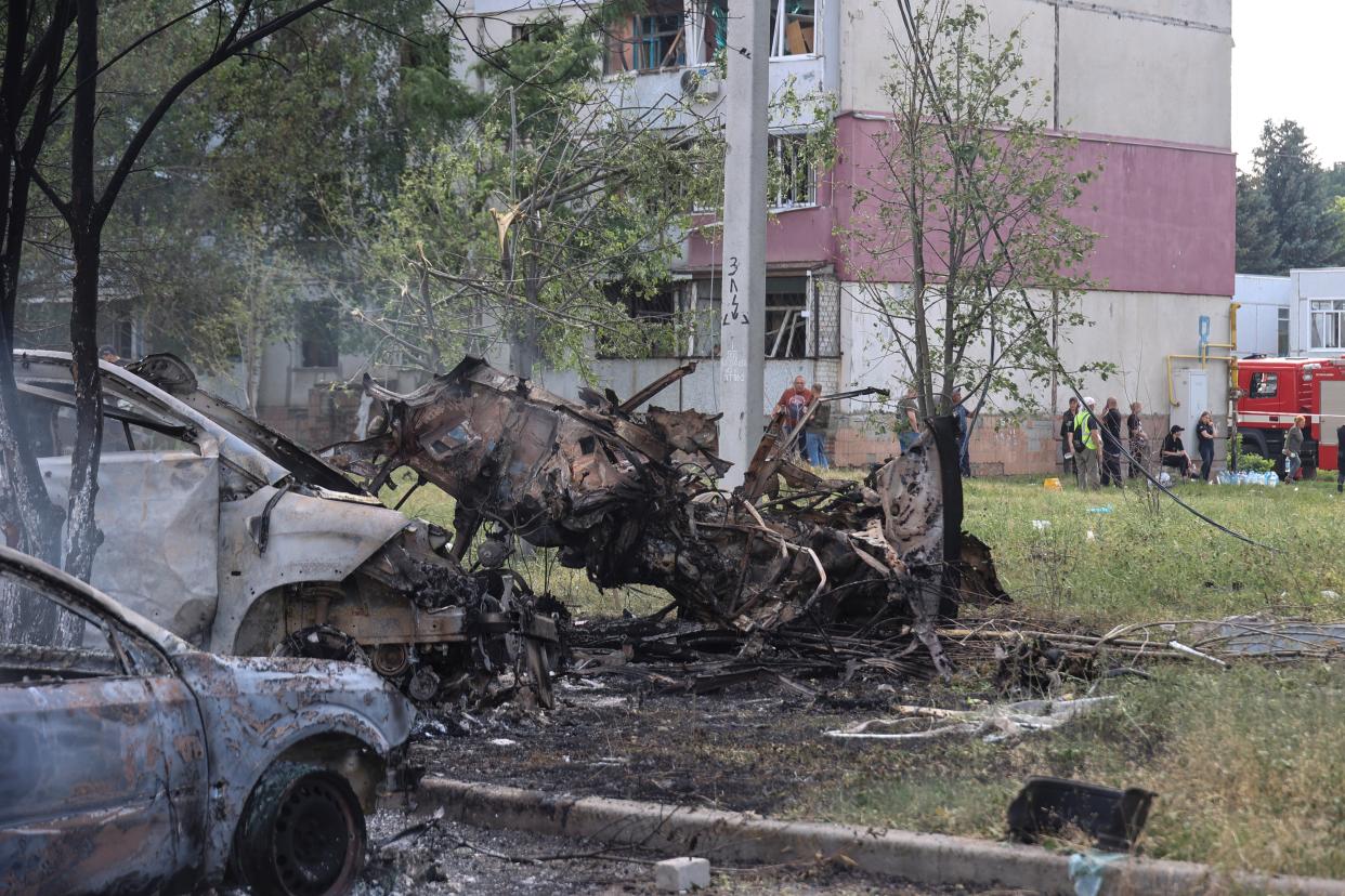 Burned cars are seen at a site of a Russian military strike in the town of Pervomaiskyi (REUTERS)
