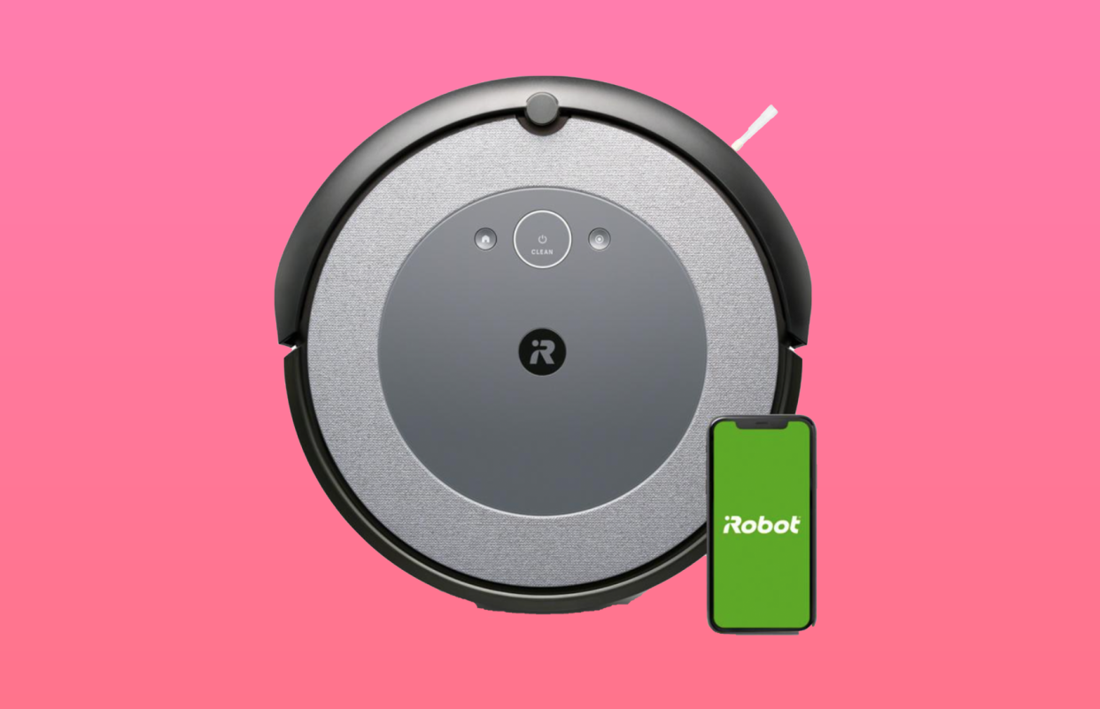 Roomba vacuum with iPhone shown nearby.