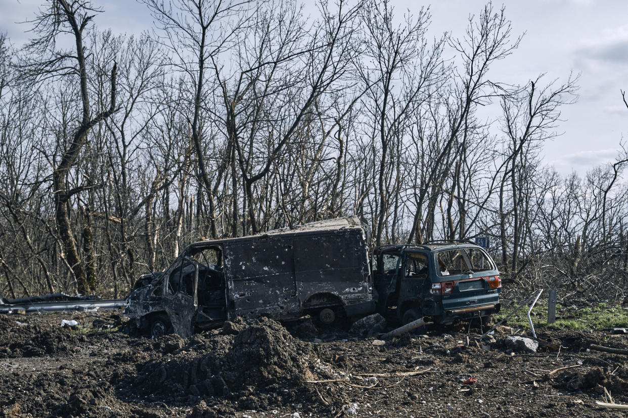 Cars covered with bullet holes are seen on the road of Bakhmut, the site of heavy battles with Russian troops in the Donetsk region, Ukraine, Sunday, April 9, 2023. (AP Photo/Libkos)