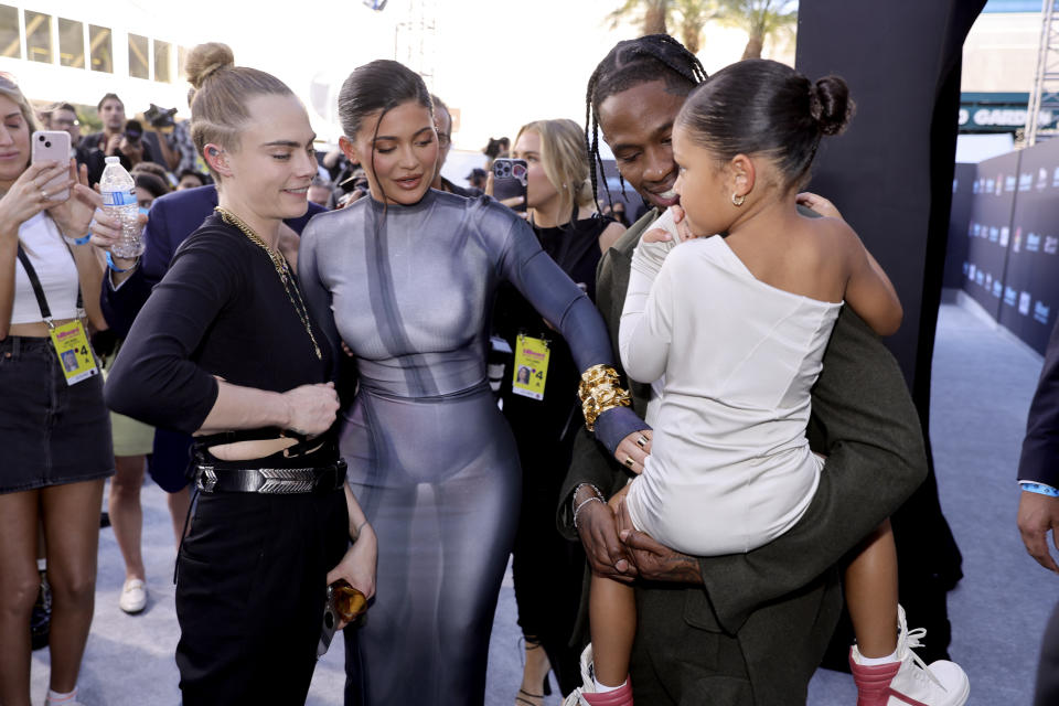 Cara Delevingne, Kylie Jenner, Travis Scott, and Stormi Webster attend the 2022 Billboard Music Awards 