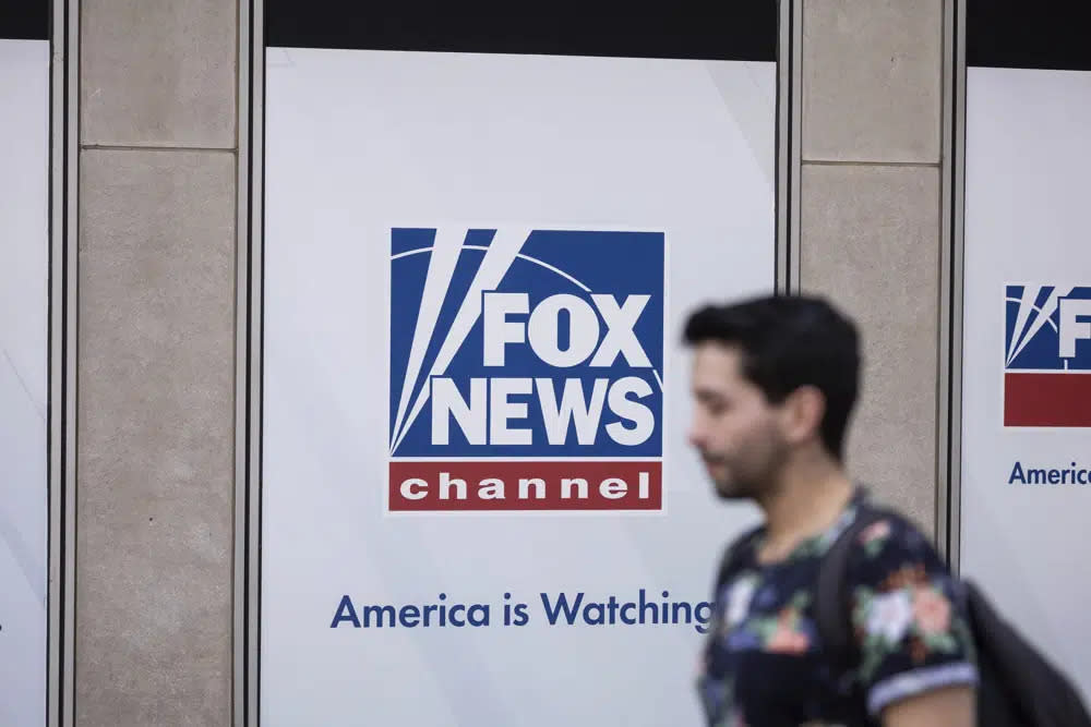 A person walks past the Fox News Headquarters in New York, April. 12, 2023. (AP Photo/Yuki Iwamura, File)