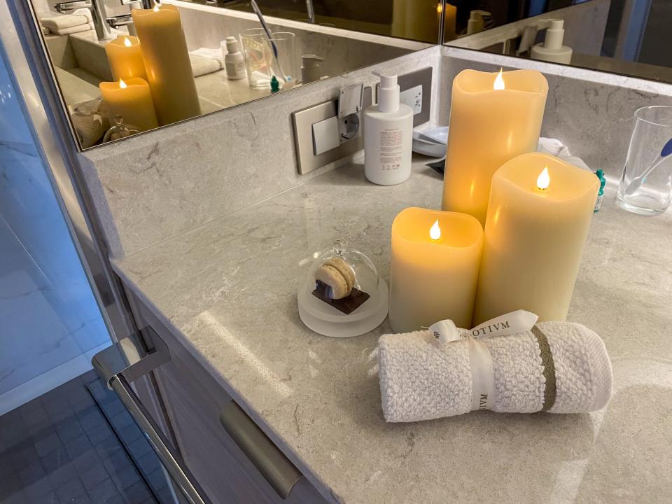 candles, towel, and macaron in deluxe veranda suite on Silversea Silver Ray