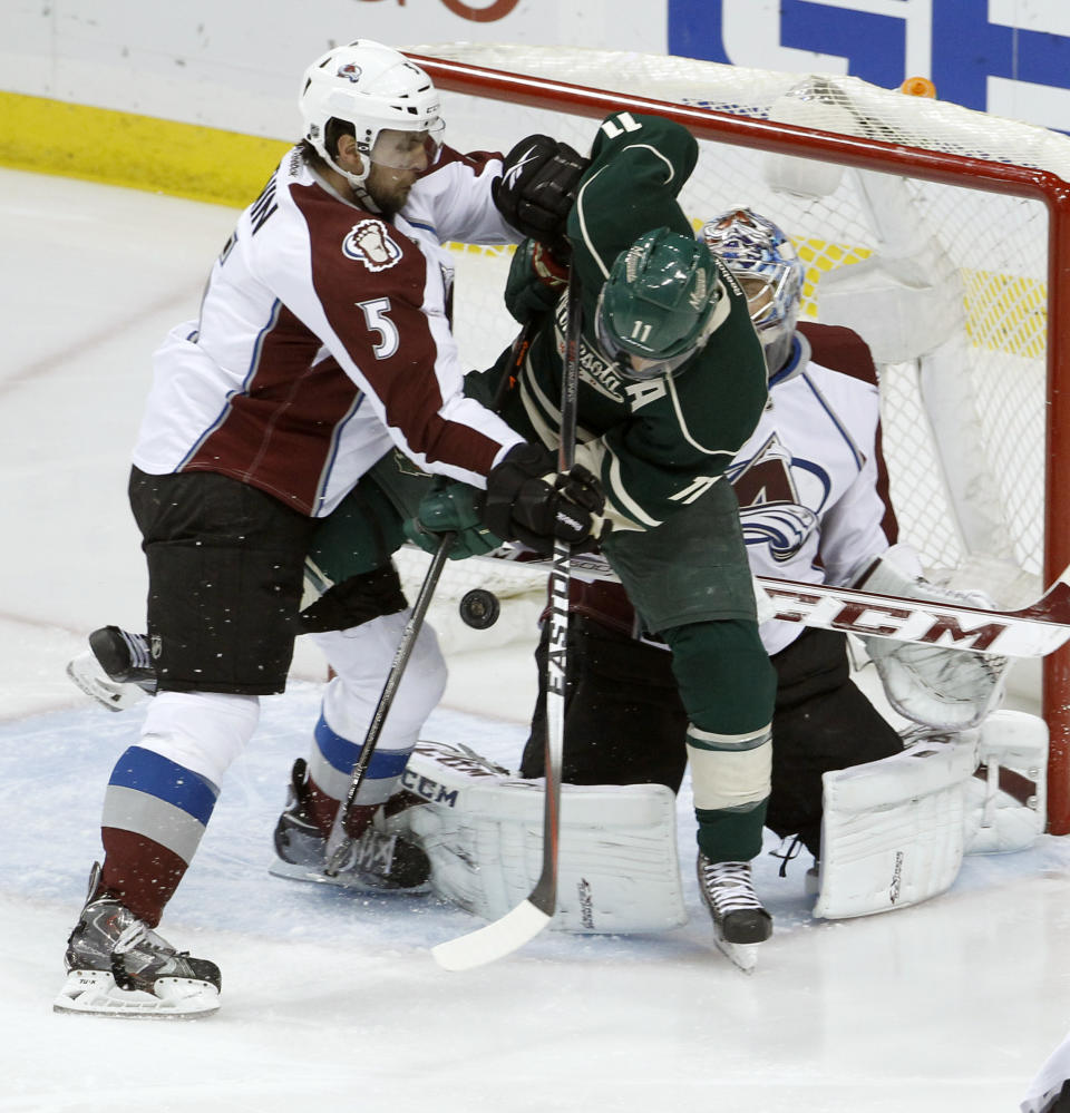 A shot by Minnesota Wild defenseman Ryan Suter gets past Wild left wing Zach Parise (11) and Colorado Avalanche defenseman Nate Guenin (5) and goalie Semyon Varlamov, right, of Russia, for a goal during the first period of Game 6 of an NHL hockey first-round playoff series in St. Paul, Minn., Monday, April 28, 2014. (AP Photo/Ann Heisenfelt)
