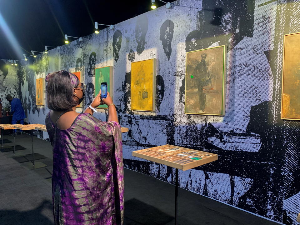 A visitor takes a picture of an art piece displayed at the ART X fair in Lagos, Nigeria, November 5, 2021. Picture taken November 5, 2021. REUTERS/Nneka Chile