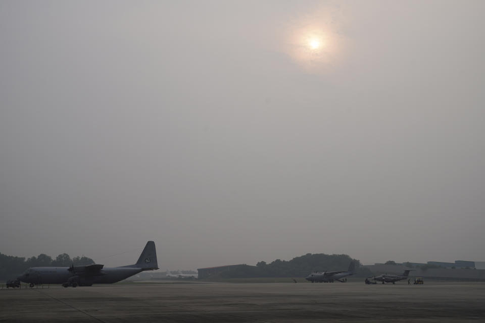 A military plane is parked before a cloud seeding mission at Subang military airbase as sky is shrouded with haze in Subang, Malaysia, Thursday, Sept. 19, 2019. Indonesian forest fires spread health-damaging haze across the country and into neighboring Malaysia and Singapore. Malaysian authorities used cloud seeding Monday in an attempt to clear the thick haze engulfing the nation's capital. (AP Photo/Vincent Thian)