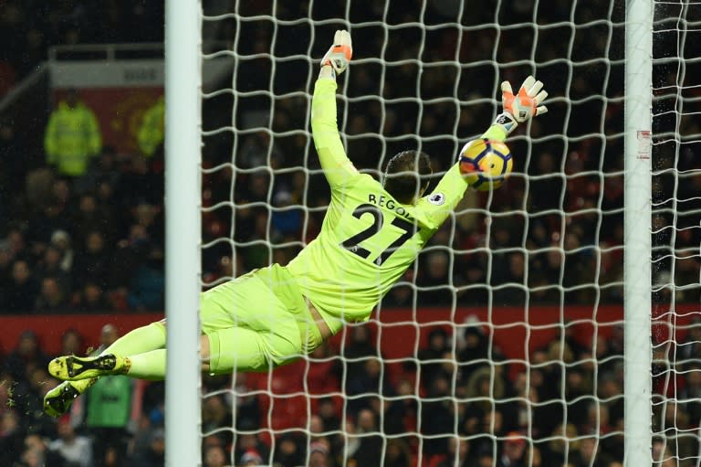 Bournemouth's goalkeeper Asmir Begovic jumps for a shot that rebounds off the post during their match against Manchester United in Manchester, north west England, on December 13, 2017