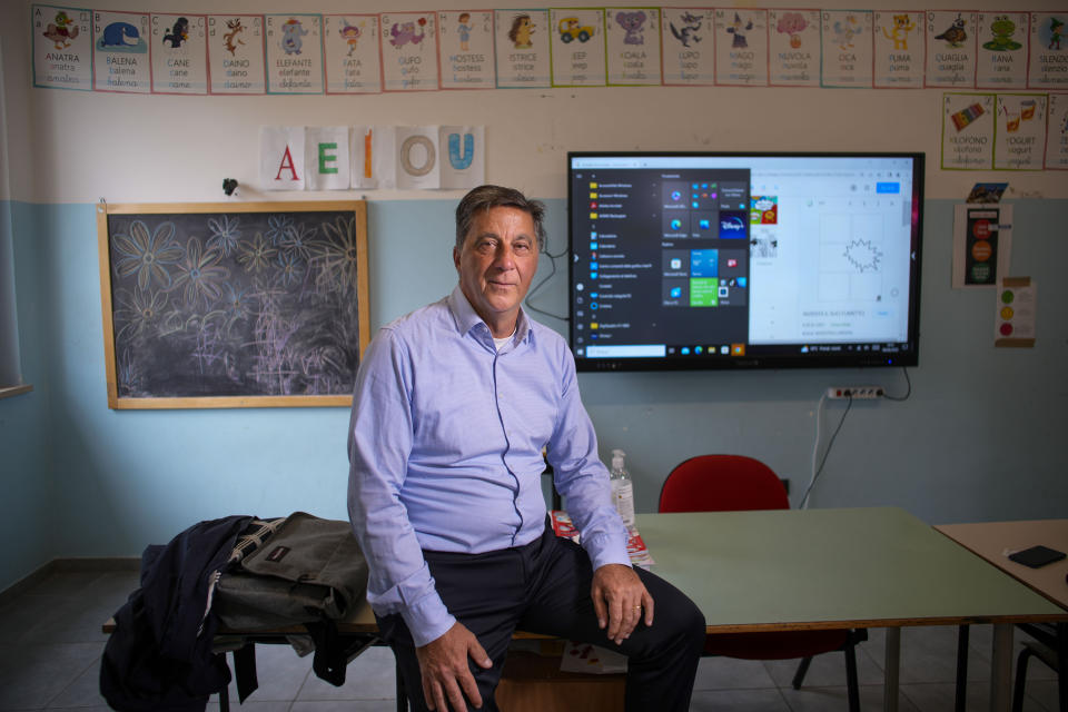 Marcello Ticchioni, an elementary school teacher, poses for a picture in his classroom in Cermignano, near Teramo in central Italy, Tuesday, June 6, 2023. (AP Photo/Domenico Stinellis)