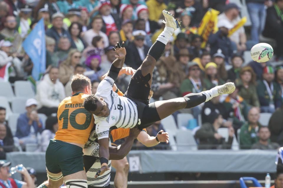 Jerry Tuwai of Fiji flies through the air against Australia in a semi final match during the Rugby World Cup 7's championship held in Cape Town, South Africa, Sunday, Sept. 11, 2022. (AP Photo/Halden Krog)
