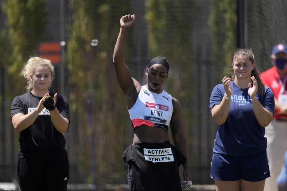 Gwendolyn Berry lifts her arm during introductions for the prelims of the women's hammer throw at the U.S. Olympic Track and Field Trials Thursday, June 24, 2021, in Eugene, Ore. (AP Photo/Ashley Landis)