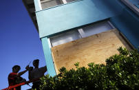 <p>Paulita Kundid, left and her brother Mike Kundid board up their apartment building ahead of Hurricane Irma in Daytona Beach, Fla., Friday, Sept. 8, 2017. (Photo: David Goldman/AP) </p>