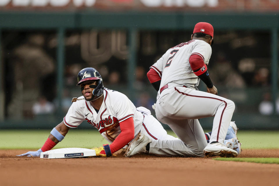 Atlanta Braves' Ronald Acuna Jr., left, is tagged out by Arizona Diamondbacks shortstop Geraldo Perdomo (2) while trying to steal second base during the first inning of a baseball game Saturday, July 30, 2022, in Atlanta. (AP Photo/Butch Dill)