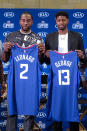 Kawhi Leonard, left, and Paul George pose with their new team jerseys during a press conference in Los Angeles, Wednesday, July 24, 2019. Nearly three weeks after the native Southern California superstars shook up the NBA by teaming up with the Los Angeles Clippers, the dynamic duo makes its first public appearance. (AP Photo/Ringo H.W. Chiu)