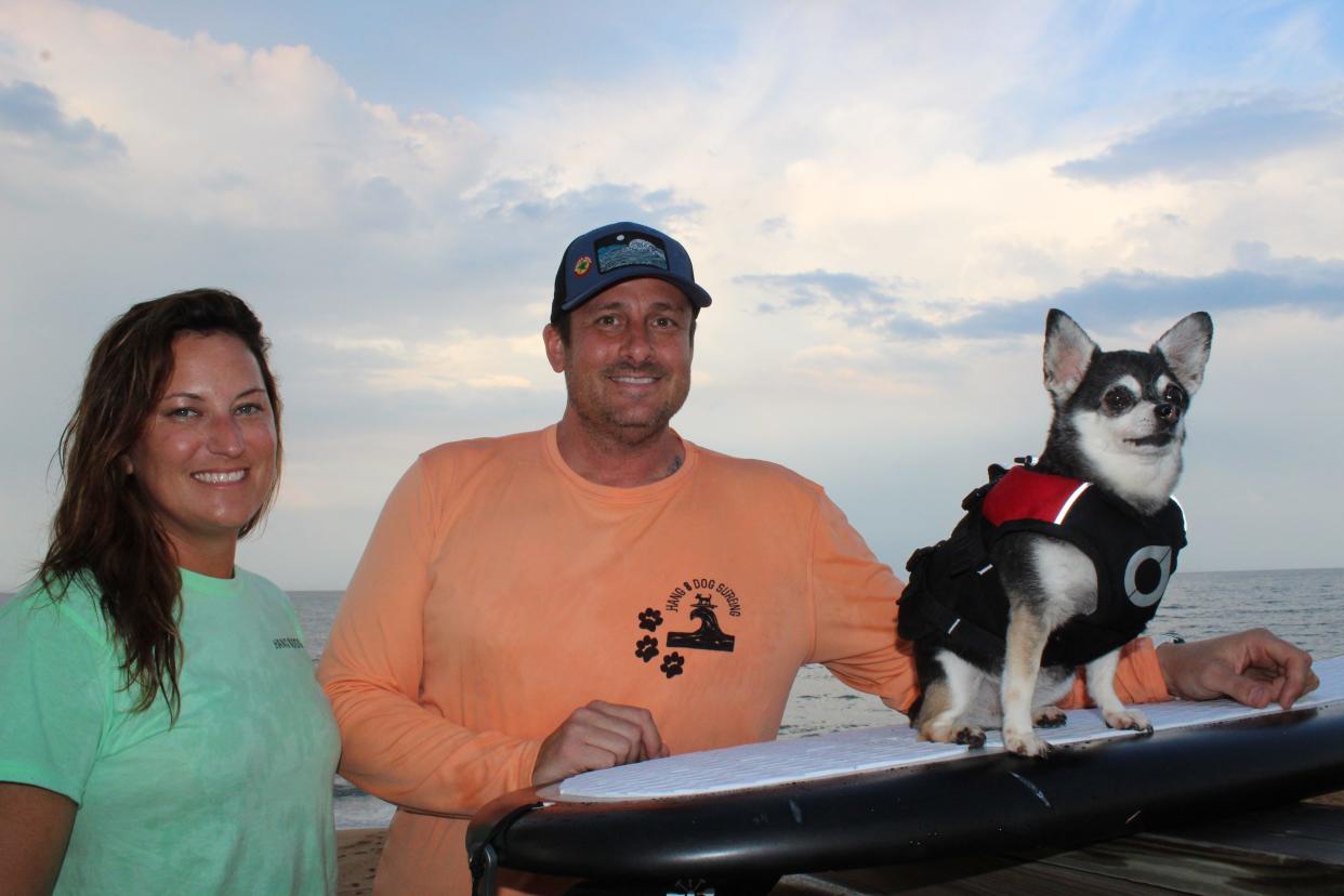 Flagler Beach Mayor Suzie Johnston, Commissioner Eric Cooley and Wednesday, the surfing chihuahua. Cooley and Johnson are the organizers behind Saturday's Hang 8 Dog Surfing event in Flagler Beach.