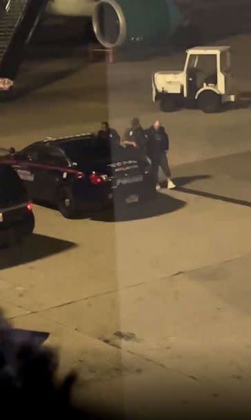 PHOTO: Bystander footage captures police escorting a passenger off a Frontier Airlines flight after it made an emergency landing at Hartsfield-Jackson Atlanta International Airport, Nov. 11, 2022. (Obtained by ABC News)