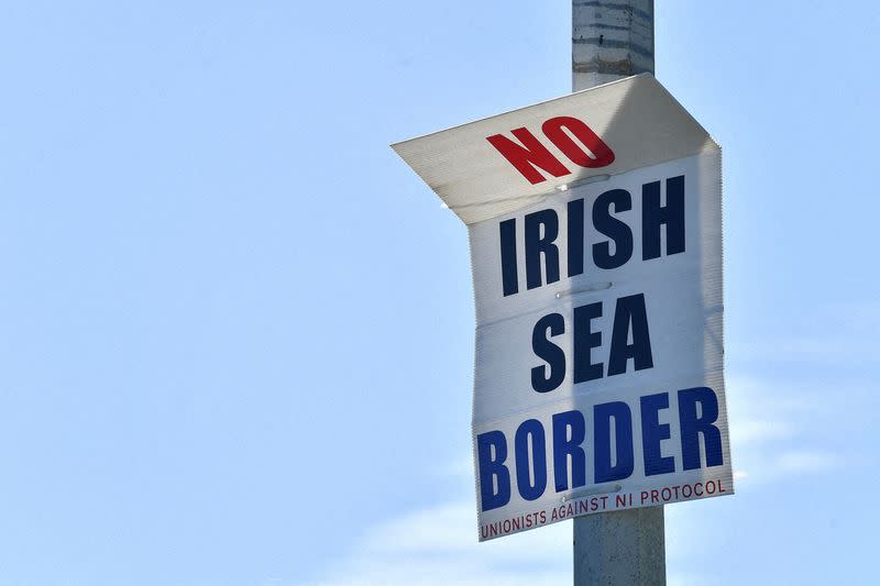 FILE PHOTO: A poster reading "No Irish Sea border" is seen in the port of Larne, Northern Ireland