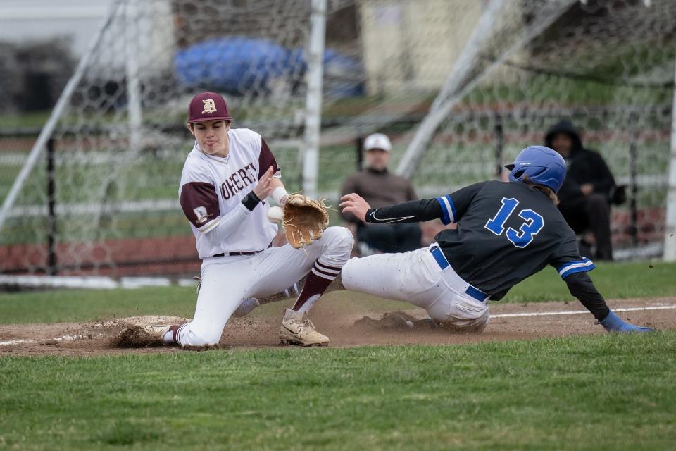 Leominster's Reece Lora steals third ahead of the throw to Doherty's Aiden Murphy.