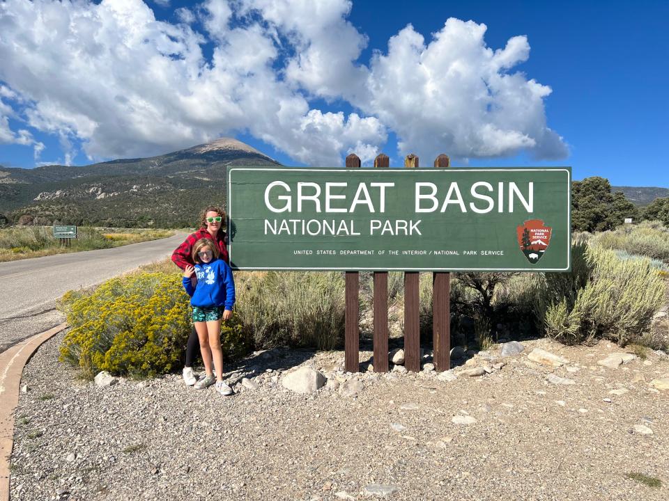 Writer and daughter in front of Great Basin National Park sign