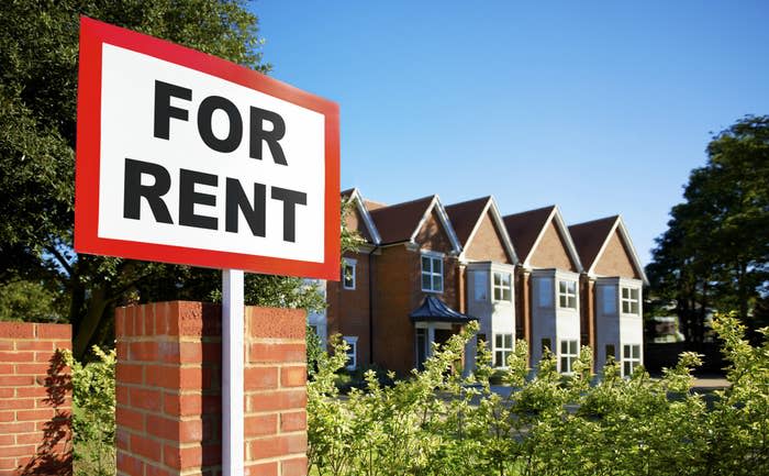 For rent sign near a row of townhomes