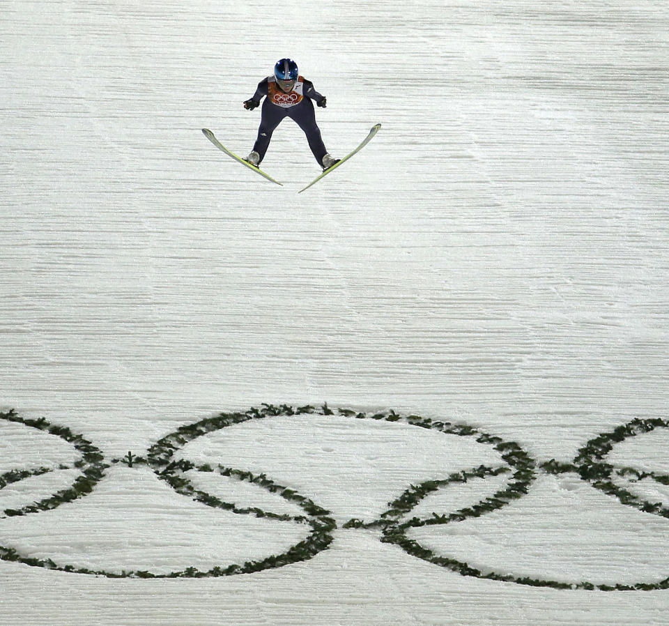 Germany's Carina Vogt jumps over the Olympic Rings on her second run during the women's normal hill ski jumping final at the 2014 Winter Olympics, Tuesday, Feb. 11, 2014, in Krasnaya Polyana, Russia. (AP Photo/Charlie Riedel)