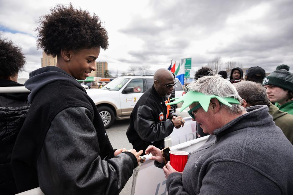 North High basketball's Nalajah Christopher, left, shows Lee Hazzard of Leicester his 2023 State Championship ring during the Worcester County St. Patrick’s Parade Sunday.