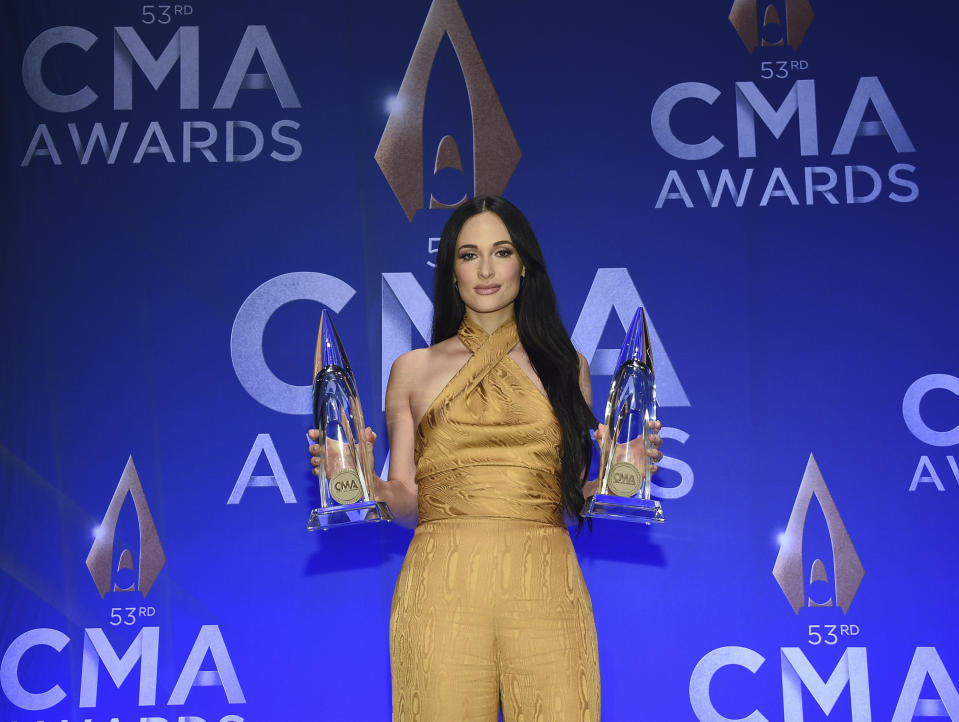 Singer-songwriter Kacey Musgraves poses in the press room with awards for female vocalist of the year and music video of the year at the 53rd annual CMA Awards at Bridgestone Arena on Wednesday, Nov. 13, 2019, in Nashville, Tenn. (Photo by Evan Agostini/Invision/AP)