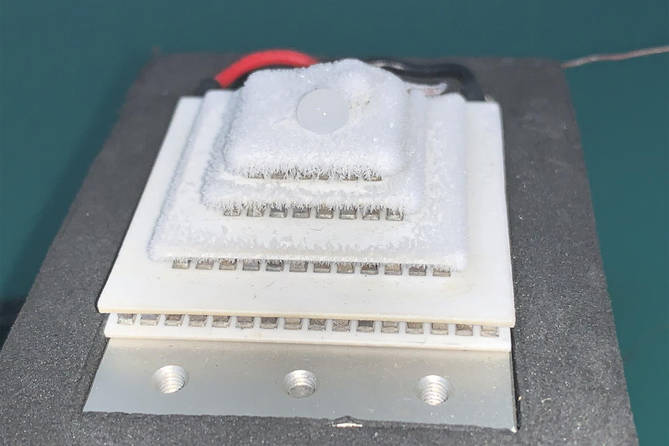 In this Aug. 21, 2019, photo, an active cooling solution produces ice crystals during a demonstration at the Huawei Thermal design lab in Dongguan in Southern China's Guangdong province. Facing a ban on access to U.S. technology, Chinese telecom equipment maker Huawei is showing it increasingly can do without American components and compete with Western industry leaders in pioneering research. (AP Photo/Ng Han Guan)