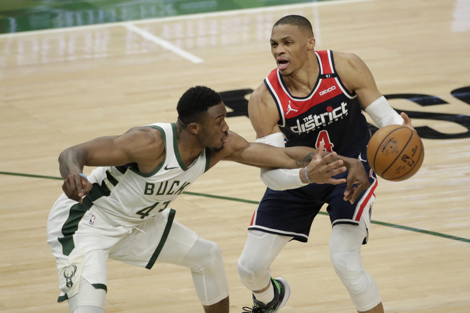 Washington Wizards' Russell Westbrook (4) is fouled by Milwaukee Bucks' Thanasis Antetokounmpo (43) during the first half of an NBA basketball game Wednesday, May 5, 2021, in Milwaukee. (AP Photo/Aaron Gash)