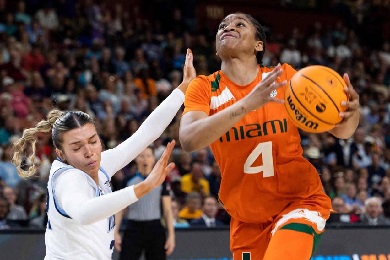 Miami's Jasmyne Roberts (4) drives to the basket against Villanova's Bella Runyan (32) in the second half of a Sweet 16 college basketball game.