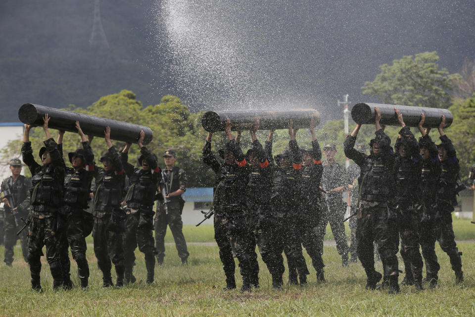 FILE - Chinese soldiers based in Hong Kong demonstrate their skill at the Shek Kong barracks of People's Liberation Army (PLA) Garrison during an open day to celebrate the upcoming 21st anniversary of the city's return to Chinese sovereignty from British rule in Hong Kong on June 30, 2018. China's military says the former head of internal security in the Xinjiang region will lead the People's Liberation Army's garrison in Hong Kong, in the latest in a series of moves aimed at bringing the semiautonomous city under Beijing's tight control. (AP Photo/Kin Cheung, File)