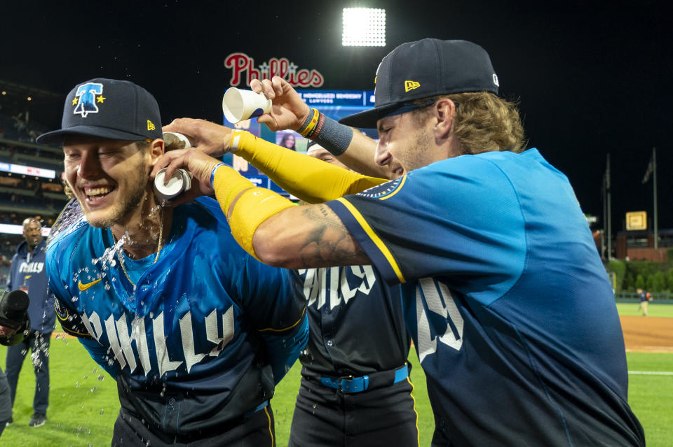 Philadelphia Phillies' Alec Bohm, left, is splashed by Brandon Marsh, center, and Bryson Stott, right, following a baseball game against the San Francisco Giants, Friday, May 3, 2024, in Philadelphia. (AP Photo/Chris Szagola)