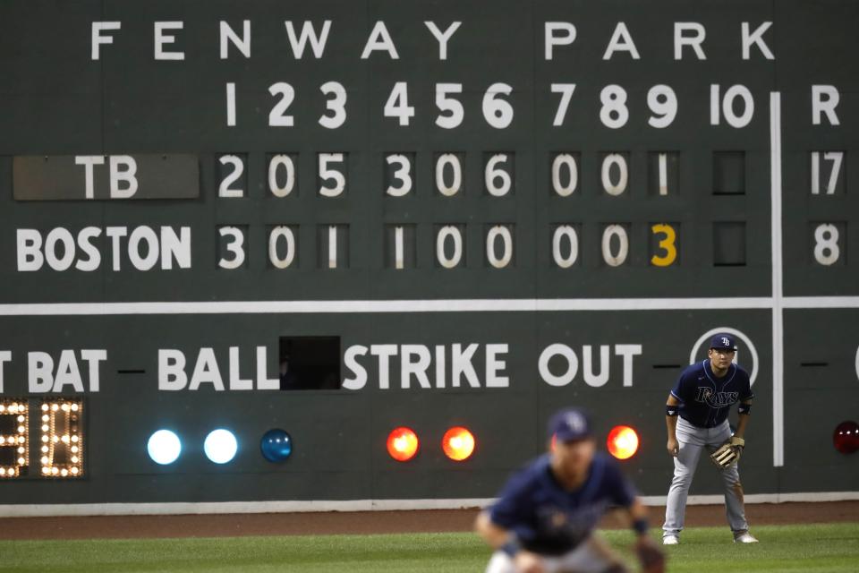 Tampa Bay Rays' Yoshitomo Tsutsugo, right, plays in left field during the ninth inning of a baseball game against the Boston Red Sox, Thursday, Aug. 13, 2020, in Boston. (AP Photo/Michael Dwyer)