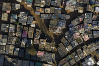 This aerial photo shows the an informal settlement in Ngodwana, South Africa, Thursday, July 2, 2020. Across Africa and around the world, the COVID-19 pandemic has disrupted the supply of antiretroviral drugs to many of the more than 24 million people who take them, endangering their lives. An estimated 7.7 million people in South Africa are HIV positive, the largest number in the world, and 62% of them take the antiretroviral drugs that suppress the virus and prevent transmission. (AP Photo/Bram Janssen)