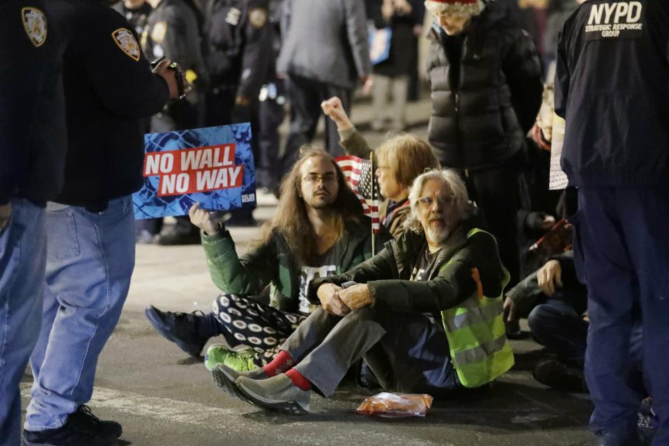 Protesters of President Donald Trump's national emergency declaration block traffic near Trump International Hotel & Tower on Friday, Feb. 15, 2019, in New York. (AP Photo/Frank Franklin II)