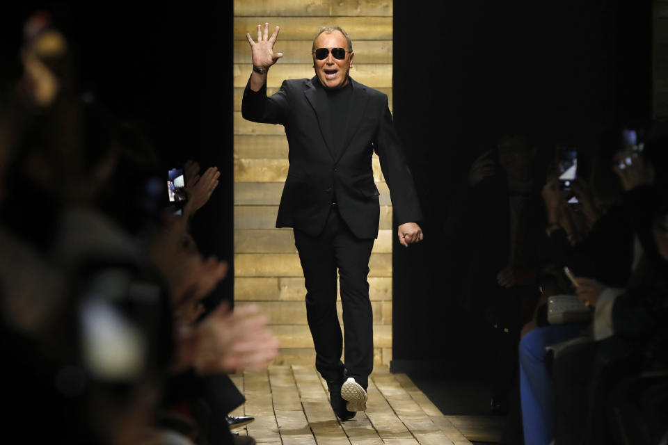 Designer Michael Kors acknowledges audience applause after his collection was modeled during Fashion Week in New York, Wednesday, Feb. 12, 2020. (AP Photo/Richard Drew)