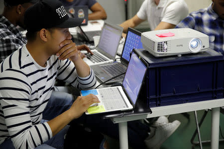 Student Nicky Hour, aged 25, works in his web development class as part of professional training at the Simplon.co school specialized in digital sector in Montreuil, near Paris, France, June 14, 2018. Picture taken June 14, 2018. REUTERS/Philippe Wojazer