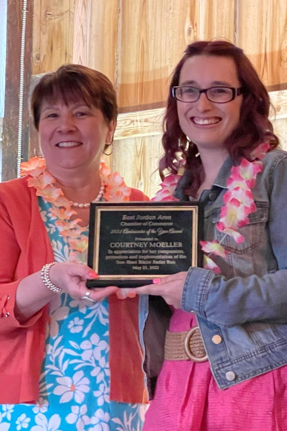 Ambassador of the Year award was presented to Courtney Moeller (right) for her compassion, promotion and implementation of the Sno-Blast Bikini Radar Run the past four years.