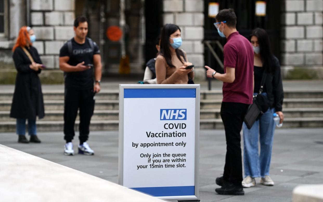 People queue up at a Covid-19 vaccination centre in London on 26 July 2021 - Andy Rain/Shutterstock