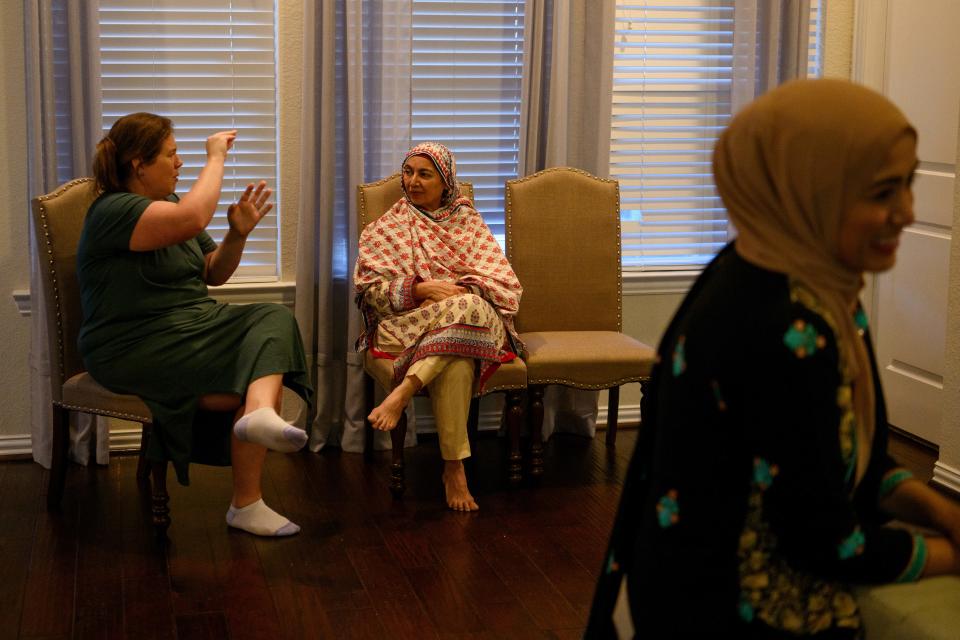 Heather Hall, a Christian from Cypress, talks with Shanaz Ghani, a Muslim, as friends of different faiths gather for iftar at Shariq Ghani's home in Richmond, Texas, on April 2, 2024.
