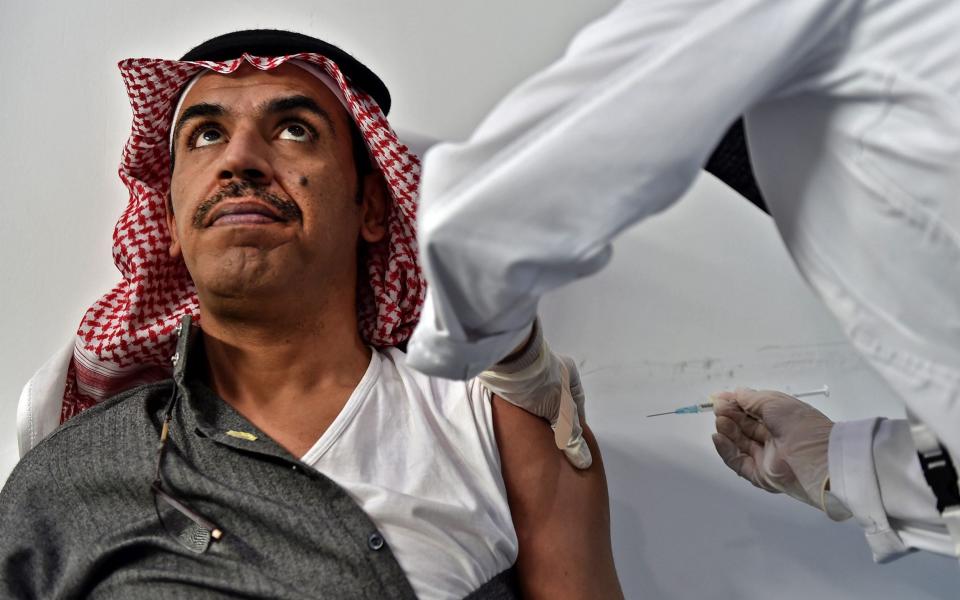 A nurse administers a dose of vaccine against Covid-19 in the capital Riyadh - AFP