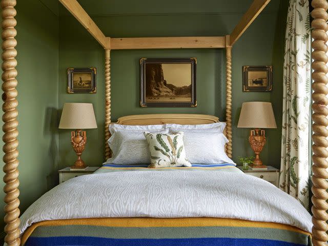 green bedroom with four poster bed