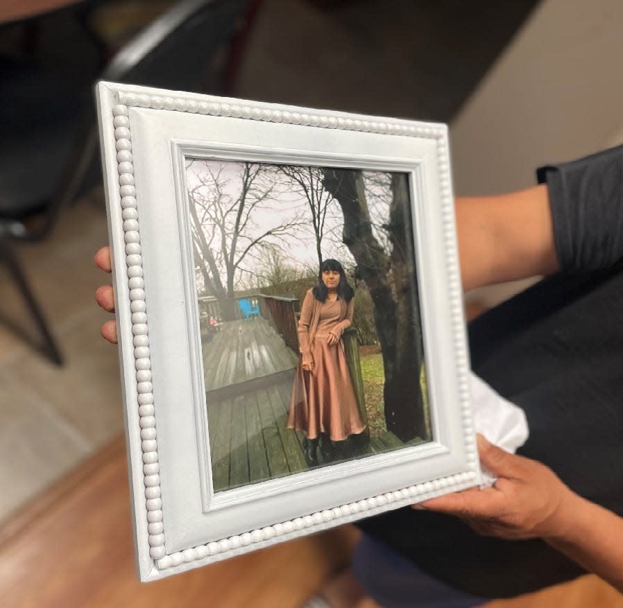 Maria Gaspar's father holds a picture of his daughter weeks after she was killed in a wreck on April 13.