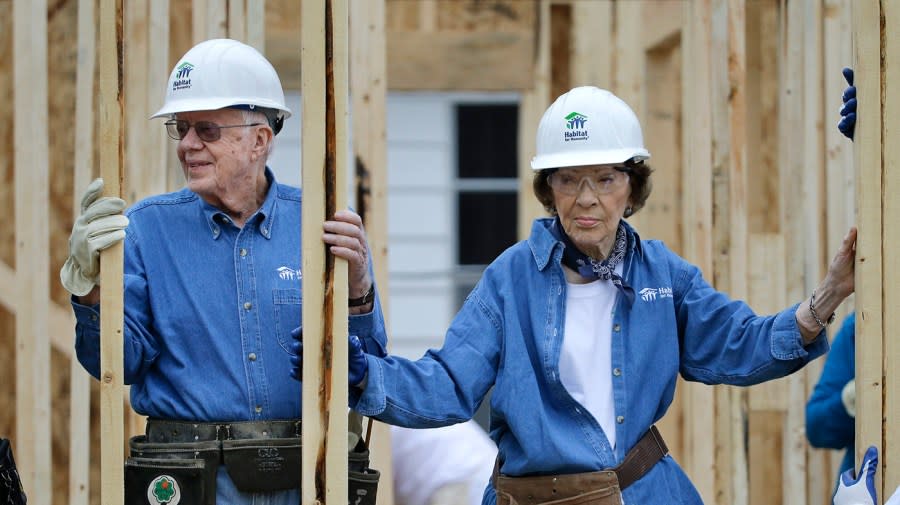 Former President Jimmy Carter and his wife, Rosalynn Carter, right, work at a Habitat for Humanity building site Monday, Nov. 2, 2015, in Memphis, Tenn. Carter and his wife, Rosalynn, have volunteered a week of their time annually to Habitat for Humanity since 1984, events dubbed “Carter work projects” that draw thousands of volunteers and take months of planning. (AP Photo/Mark Humphrey)