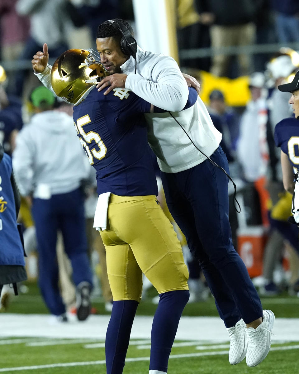 Notre Dame head coach Marcus Freeman is lifted in the air by defensive lineman Chris Smith during the second half of an NCAA college football game against Clemson Saturday, Nov. 5, 2022, in South Bend, Ind. Notre Dame won 35-14. (AP Photo/Charles Rex Arbogast)