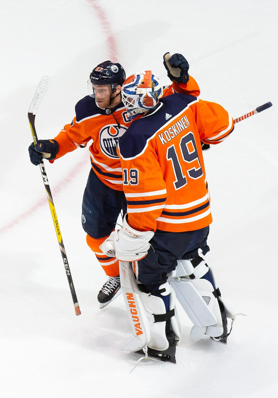 Edmonton Oilers' Connor McDavid (97) and Mikko Koskinen (19) celebrate the team's win over the Chicago Blackhawks in an NHL hockey playoff game Monday, Aug. 3, 2020, in Edmonton, Alberta. (Codie McLachlan/The Canadian Press via AP)