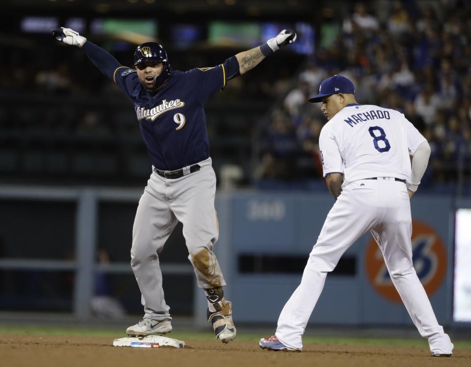 Milwaukee Brewers' Manny Pina reacts after hitting a double during the seventh inning of Game 4 of the National League Championship Series baseball game against the Los Angeles Dodgers Tuesday, Oct. 16, 2018, in Los Angeles. (AP Photo/Matt Slocum)